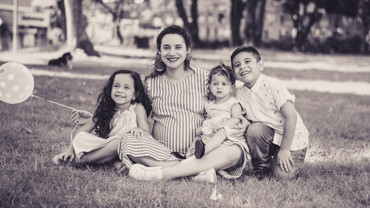 greyscale photo of woman and children